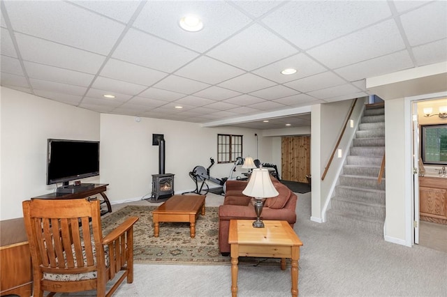 716 Mariner Cir, Webster, NY 14580 - carpeted living room featuring stairway, a wood stove, a paneled ceiling, recessed lighting, and baseboards