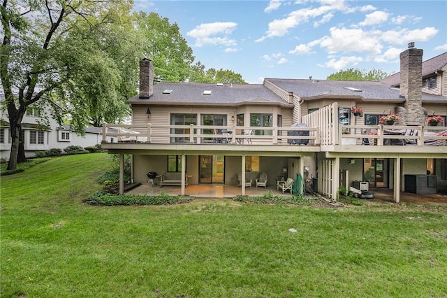 716 Mariner Cir, Webster, NY 14580 - back of property with a patio area, a yard, a deck, and a chimney