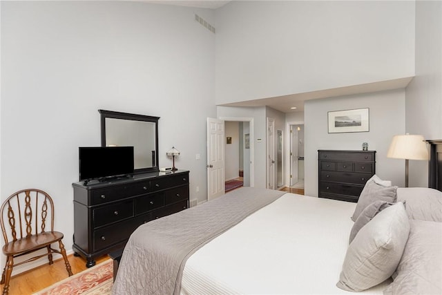 716 Mariner Cir, Webster, NY 14580 - bedroom with a towering ceiling and light wood-style floors