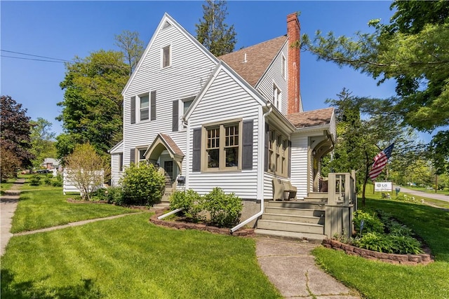 456 N Main St, Benton, NY 14527 - view of front facade with a front yard, a chimney, and roof with shingles