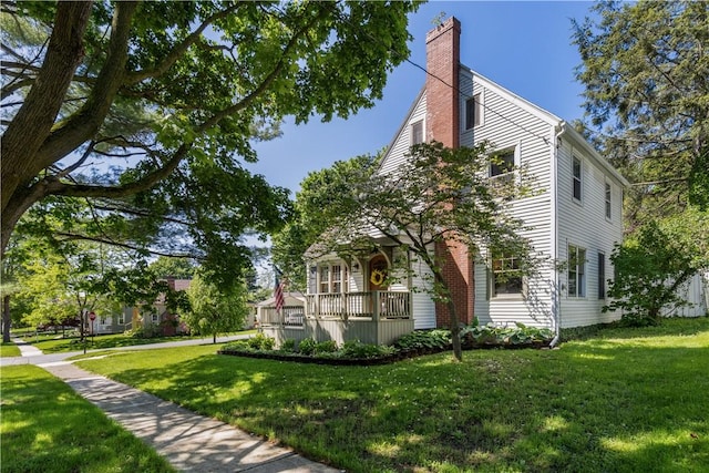 456 N Main St, Benton, NY 14527 - view of front of house with a chimney and a front lawn