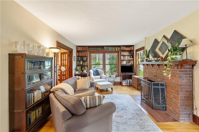 456 N Main St, Benton, NY 14527 - living area featuring a fireplace, wood finished floors, built in shelves, and french doors