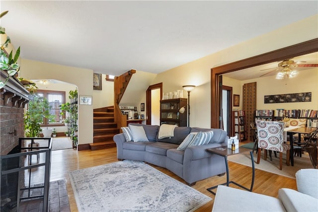 456 N Main St, Benton, NY 14527 - living area featuring stairs, a ceiling fan, light wood-type flooring, and a fireplace