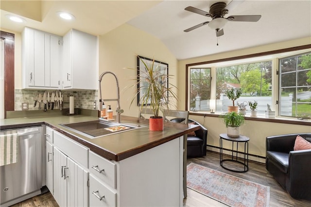456 N Main St, Benton, NY 14527 - kitchen featuring dishwasher, a sink, a peninsula, a baseboard heating unit, and tasteful backsplash
