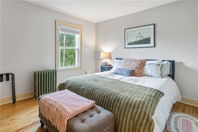 456 N Main St, Benton, NY 14527 - bedroom with radiator heating unit, wood finished floors, and baseboards