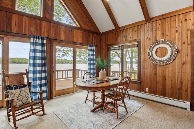 6525 Bonnie Castle Rd, Huron, NY 14590 - dining space featuring a baseboard radiator, beam ceiling, a water view, wood walls, and carpet flooring