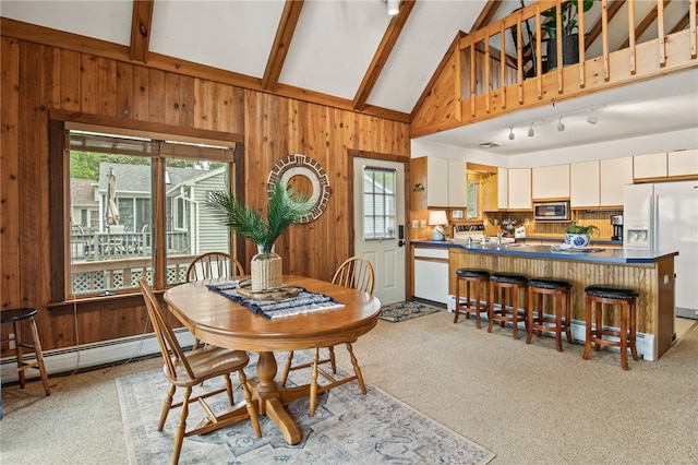 6525 Bonnie Castle Rd, Huron, NY 14590 - dining area with plenty of natural light, wooden walls, light colored carpet, and baseboard heating