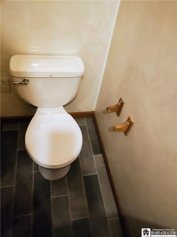 601 Falconer St, Jamestown, NY 14701 - bathroom with toilet, baseboards, and tile patterned floors