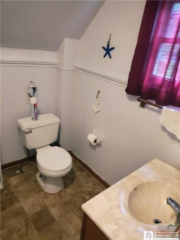 601 Falconer St, Jamestown, NY 14701 - bathroom featuring toilet, vanity, and vaulted ceiling