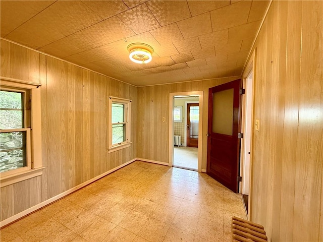 9 Weidman St, Unadilla, NY 13849 - unfurnished room with light flooring, wooden walls, and radiator heating unit