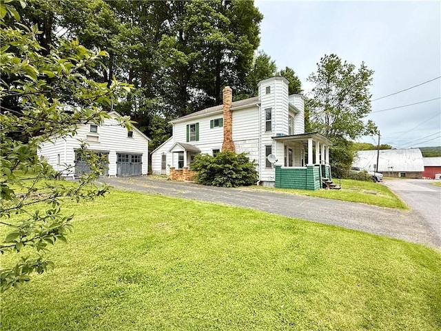 9 Weidman St, Unadilla, NY 13849 - view of side of home featuring a chimney, asphalt driveway, and a lawn
