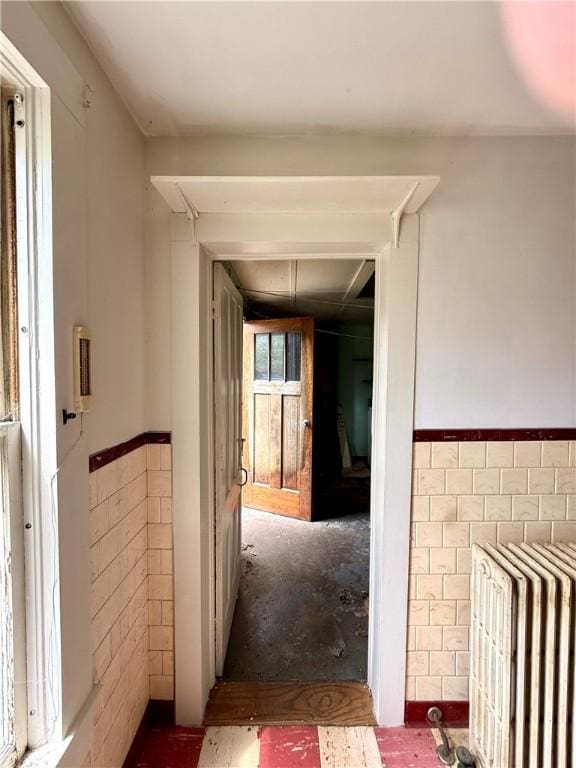 9 Weidman St, Unadilla, NY 13849 - hallway featuring wainscoting, tile walls, and attic access