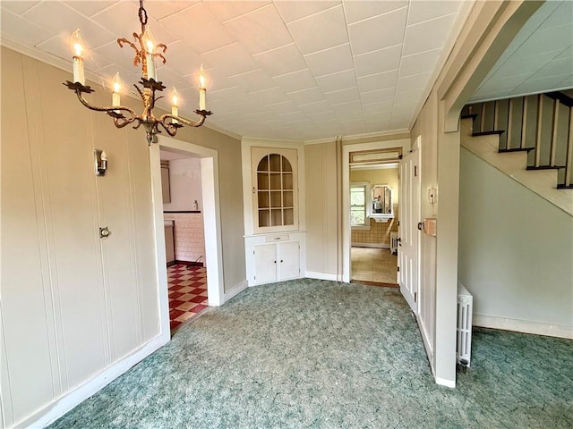 9 Weidman St, Unadilla, NY 13849 - unfurnished dining area with a chandelier, carpet flooring, crown molding, stairs, and baseboards