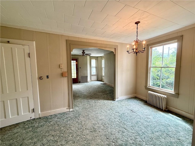 9 Weidman St, Unadilla, NY 13849 - empty room with radiator heating unit, arched walkways, carpet, a chandelier, and ornamental molding