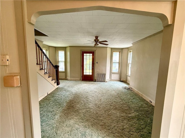 9 Weidman St, Unadilla, NY 13849 - foyer entrance featuring carpet floors, baseboards, ceiling fan, radiator, and stairway