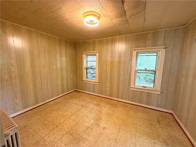 9 Weidman St, Unadilla, NY 13849 - unfurnished room featuring tile patterned floors and wooden walls