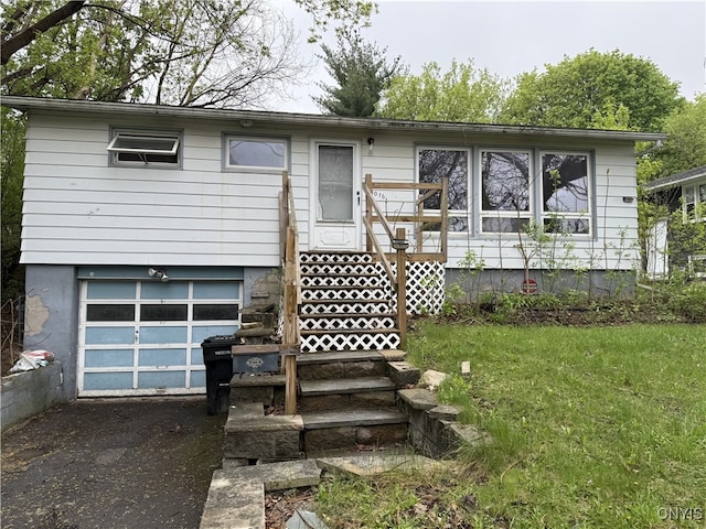 1016 Northway St, Syracuse, NY 13224 - view of front facade featuring a garage, asphalt driveway, and a front lawn