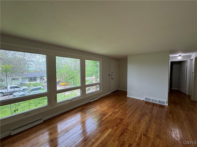 1016 Northway St, Syracuse, NY 13224 - empty room with a baseboard radiator, wood finished floors, and baseboards