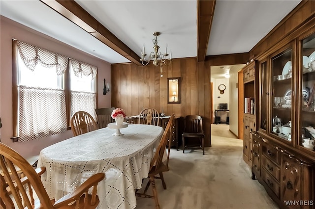163 Shepard Ave, Tonawanda-Town, NY 14217 - dining space with beam ceiling, wooden walls, a chandelier, and light carpet