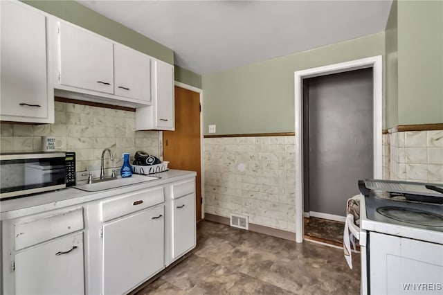 163 Shepard Ave, Tonawanda-Town, NY 14217 - kitchen with stainless steel microwave, light countertops, white cabinets, a sink, and white range with electric cooktop