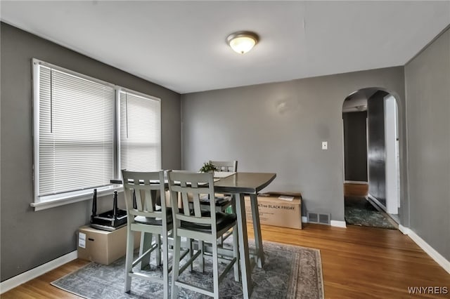 163 Shepard Ave, Tonawanda-Town, NY 14217 - dining room with arched walkways, wood finished floors, and baseboards