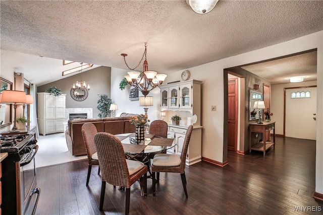 218 Palmdale Dr, Amherst, NY 14221 - dining space with a textured ceiling, a fireplace, a chandelier, dark wood finished floors, and vaulted ceiling