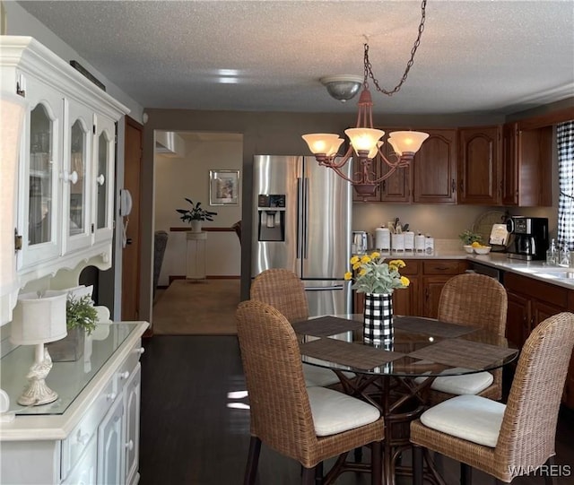 218 Palmdale Dr, Amherst, NY 14221 - dining space with a chandelier and a textured ceiling