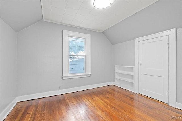 133 Avon Rd, Syracuse, NY 13206 - additional living space featuring vaulted ceiling, hardwood / wood-style floors, and baseboards