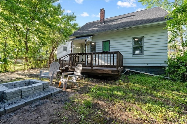 133 Avon Rd, Syracuse, NY 13206 - rear view of property featuring a chimney, a fire pit, a deck, and roof with shingles