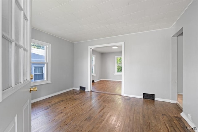 133 Avon Rd, Syracuse, NY 13206 - empty room featuring plenty of natural light, hardwood / wood-style floors, crown molding, and baseboards