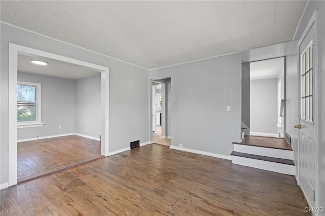 133 Avon Rd, Syracuse, NY 13206 - empty room featuring wood finished floors, baseboards, and stairway