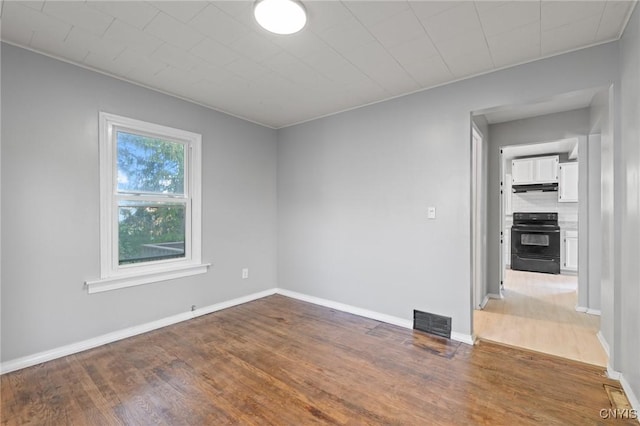 133 Avon Rd, Syracuse, NY 13206 - unfurnished room with wood finished floors and baseboards