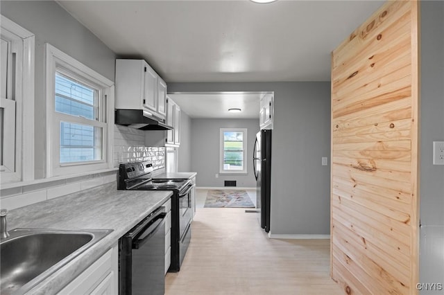 133 Avon Rd, Syracuse, NY 13206 - kitchen with under cabinet range hood, black appliances, a sink, backsplash, and white cabinets