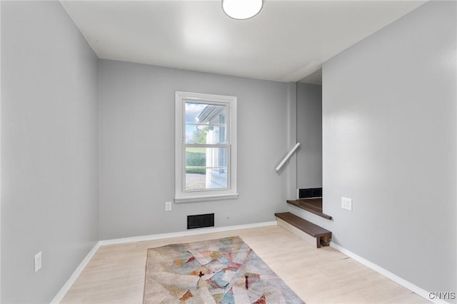 133 Avon Rd, Syracuse, NY 13206 - unfurnished living room with wood finished floors, baseboards, and stairway