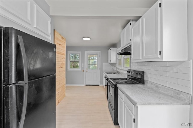 133 Avon Rd, Syracuse, NY 13206 - kitchen featuring black appliances, under cabinet range hood, a sink, white cabinets, and light wood-style floors