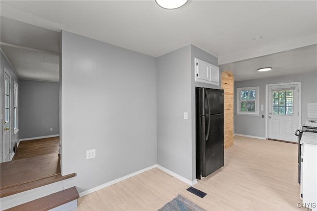 133 Avon Rd, Syracuse, NY 13206 - kitchen featuring freestanding refrigerator, light wood-style flooring, white cabinetry, baseboards, and light countertops