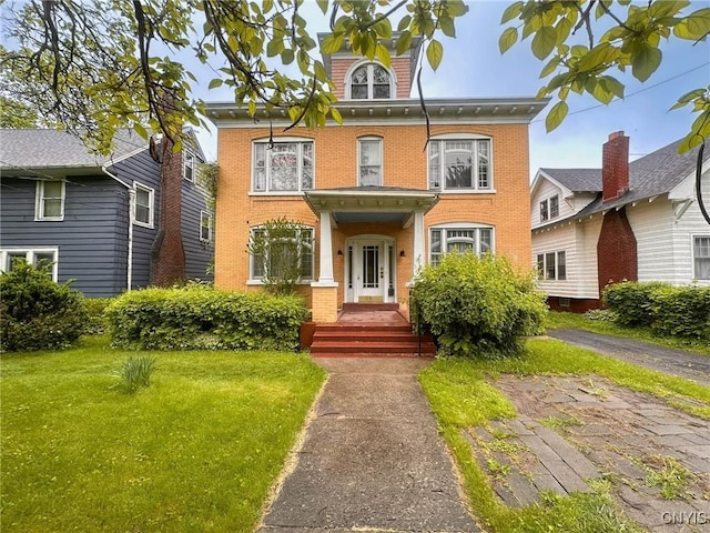 169 Pleasant St, Utica, NY 13501 - view of front of property with brick siding and a front lawn