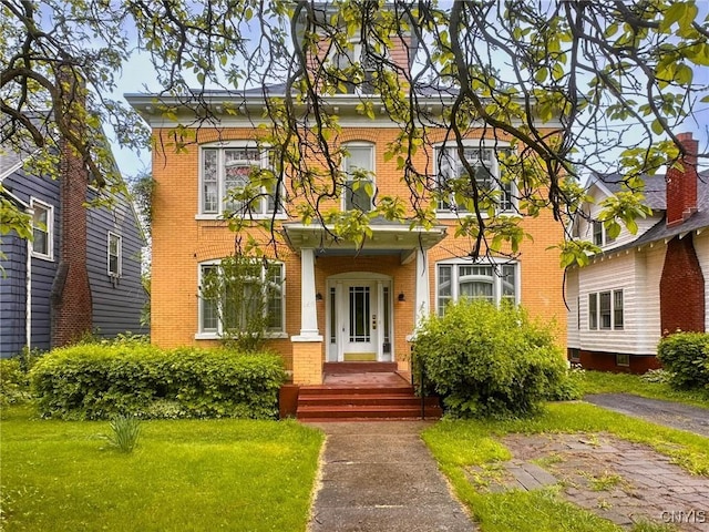 169 Pleasant St, Utica, NY 13501 - view of front of home with brick siding and a front yard