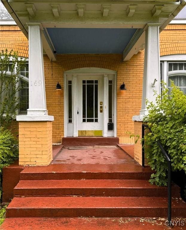 169 Pleasant St, Utica, NY 13501 - view of exterior entry with covered porch and brick siding