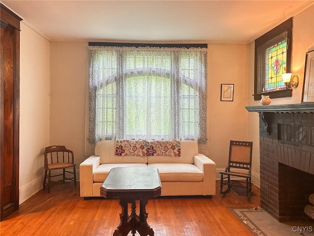 169 Pleasant St, Utica, NY 13501 - sitting room with a fireplace, baseboards, wood finished floors, and ornamental molding