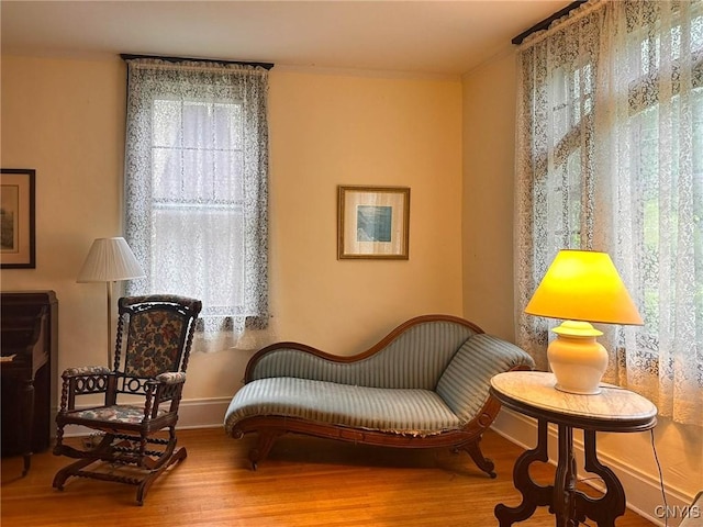 169 Pleasant St, Utica, NY 13501 - sitting room featuring wood finished floors, ornamental molding, and baseboards