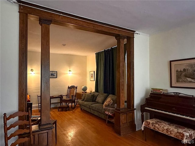 169 Pleasant St, Utica, NY 13501 - living area with wood finished floors and decorative columns
