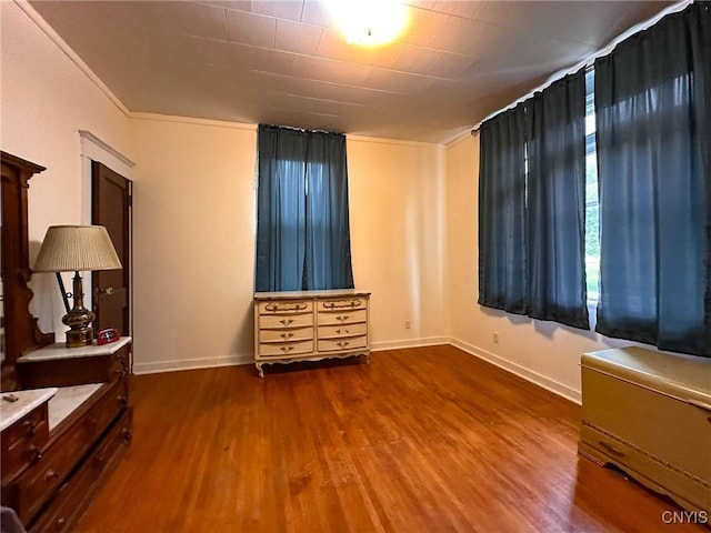 169 Pleasant St, Utica, NY 13501 - unfurnished bedroom with wood finished floors, baseboards, and ornamental molding