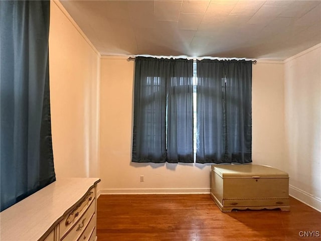169 Pleasant St, Utica, NY 13501 - empty room with wood finished floors, baseboards, and crown molding