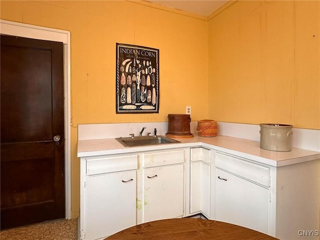 169 Pleasant St, Utica, NY 13501 - kitchen with a sink, light countertops, and white cabinets