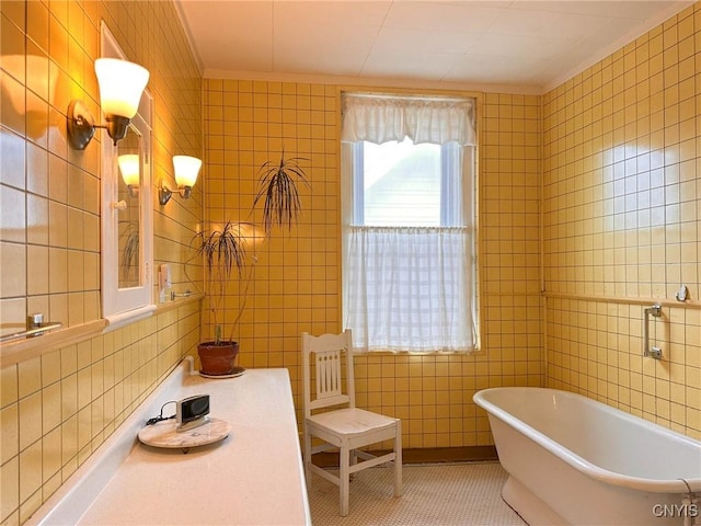 169 Pleasant St, Utica, NY 13501 - bathroom featuring tile walls, a freestanding bath, crown molding, and tile patterned flooring