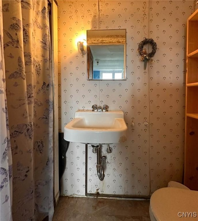 169 Pleasant St, Utica, NY 13501 - bathroom with wallpapered walls, toilet, and a sink