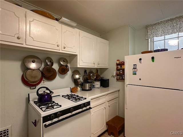 169 Pleasant St, Utica, NY 13501 - kitchen featuring white appliances, white cabinets, and light countertops