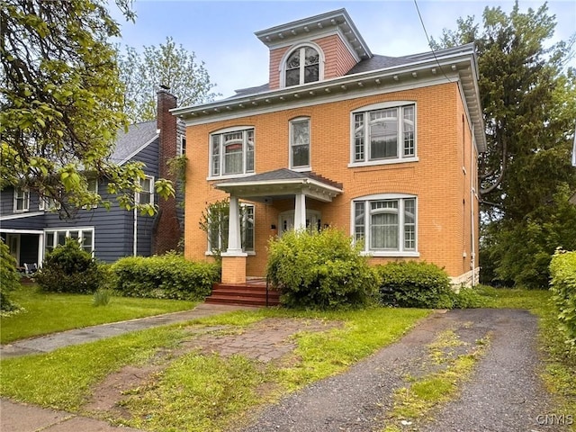 169 Pleasant St, Utica, NY 13501 - american foursquare style home featuring brick siding and a front lawn