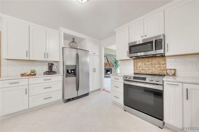 6157 Walnut Creek Ct, Clarence, NY 14051 - kitchen with appliances with stainless steel finishes, light countertops, tasteful backsplash, and white cabinetry